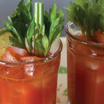 Two Glasses Of Bloody Mary's With Celery And Other Garnish