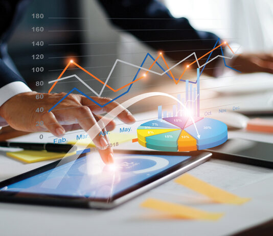 Businessman Using Tablet And Laptop Analyzing Sales Data And Economic Growth Graph Chart. Business Strategy. Digital Marketing. Business Innovation Technology Concept