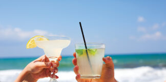 Two Cocktail Glasses In Man And Woman Hands