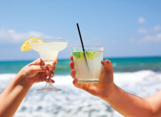 Two Cocktail Glasses In Man And Woman Hands