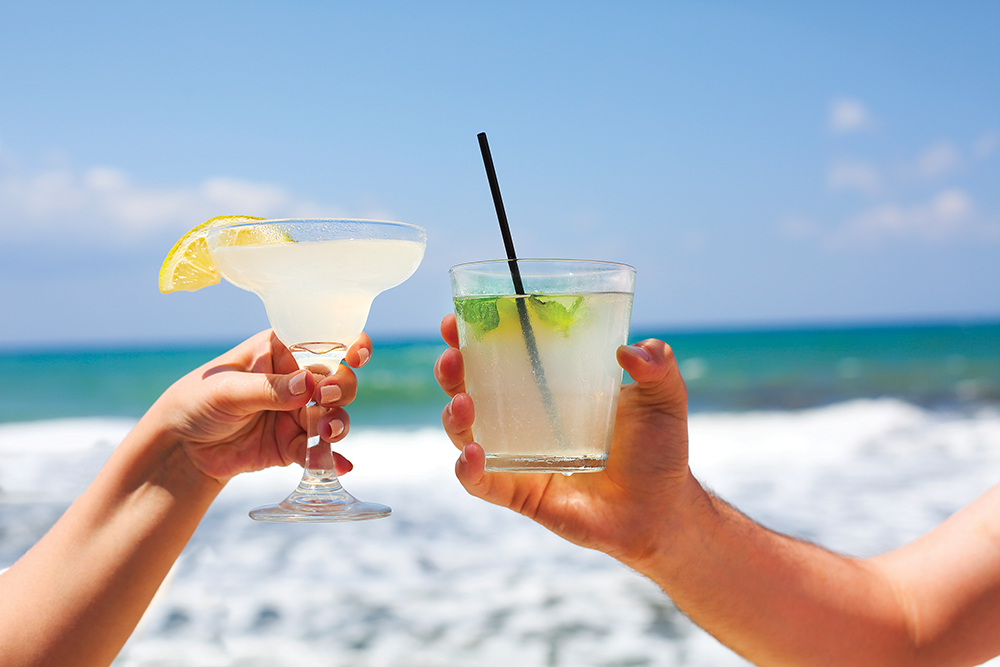 Two Cocktail Glasses In Man And Woman Hands
