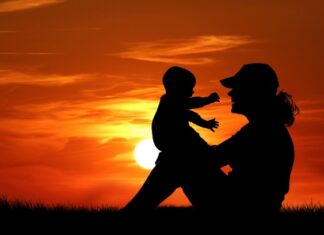 Mother And Baby At Sunset