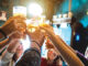 Group Of Happy Friends Drinking And Toasting Beer At Brewery Bar Restaurant Friendship Concept With Young People Having Fun Together At Cool Vintage Pub Focus On Middle Pint Glass High Iso Image