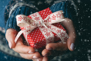 Close Up Shot Of Female Hands Holding A Small Gift