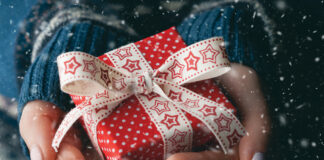 Close Up Shot Of Female Hands Holding A Small Gift