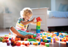 Child Playing With Colorful Toy Blocks. Kids Play.
