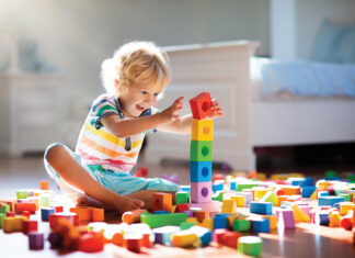 Child Playing With Colorful Toy Blocks. Kids Play.