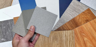 Interior Designer's Hand Holding Quartz Stone Samples Matching Color With Wood Vinyl Flooring Tiles, Engineering Wood Tiles, Stone Tiles, Solid Color Laminateds, Artificial Stone Tiles. Close Up View.