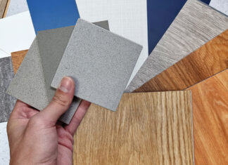 Interior Designer's Hand Holding Quartz Stone Samples Matching Color With Wood Vinyl Flooring Tiles, Engineering Wood Tiles, Stone Tiles, Solid Color Laminateds, Artificial Stone Tiles. Close Up View.