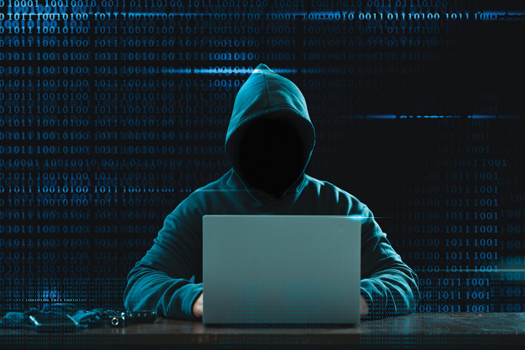 Big Financial Data Theft Concept. An Anonymous Hacker Is Hacking Highly Protected Financial Data Through Computers.