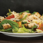 Healthy Green Organic Caesar Salad With Cheese, Chicken, Cherry Tomatoes And Croutons On A Wooden Table.