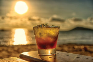 The Frozen Glass Of Mojito Cocktail On The Beach At Sunset With Blurred Background.