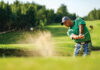 Golfer Hits Ball From A Bunker With Golf Club