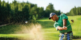 Golfer Hits Ball From A Bunker With Golf Club