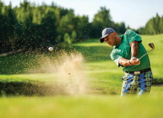 Golfer Hits Ball From A Bunker With Golf Club