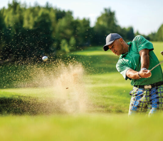 Golfer Hits Ball From A Bunker With Golf Club