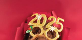 Close Up Of A Cute Poodle With Festive 2025 Glasses