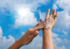 A Woman Is Applying Sunscreen And Skin Care To Protect Her Skin From Uv Rays. She Is Applying Sunscreen On Her Hands And Arms. The Sun Symbol Is A Very Sunny Background. Health And Skin Care Concept