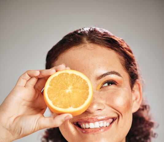 Orange, Beauty And Woman Face In Studio With A Smile For Natural Skin Glow, Cosmetic And Dermatology. Facial Results, Health And Wellness Of Aesthetic Model Person Happy With Vitamin C Fruit Idea